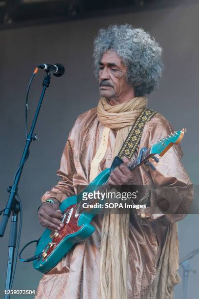 Ibrahim Ag Alhabib with a collective of Tuareg musicians from the Sahara Desert region of northern Mali, performing live on stage at Glastonbury...