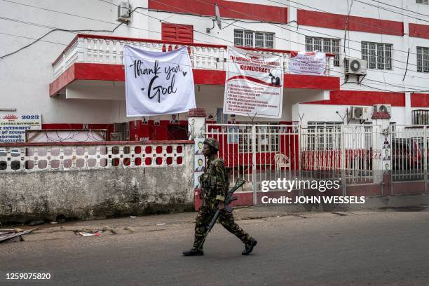 Soldier of the Sierra Leonean Armed Forces walks past the opposition party, All People's Congress headquarters in Freetown on June 26, 2023. Police...