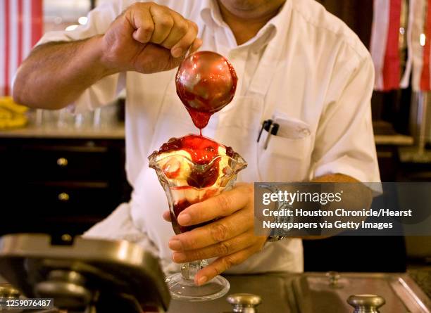 Steve Montemayor prepares a strawberry sundae at La King's Confectionery Thursday, July 29 in Galveston . James Nielsen Chronicle