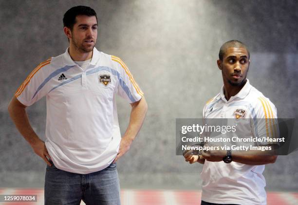 The Houston Dynamo forward Jason Garey left, and midfielder Corey Ashe right chat before a press conference on the signing of several players Friday,...