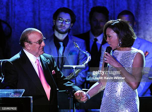 Producer Clive Davis and singer Whitney Houston speak onstage at the 2011 Pre-GRAMMY Gala and Salute To Industry Icons Honoring David Geffen at The...