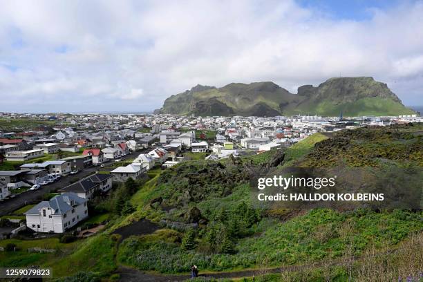 Photo taken on June 26, 2023 shows a view over the town of Vestmannaeyjabær on Heimaey on the Icelandic archipelago of Vestmannaeyjar, Westman...
