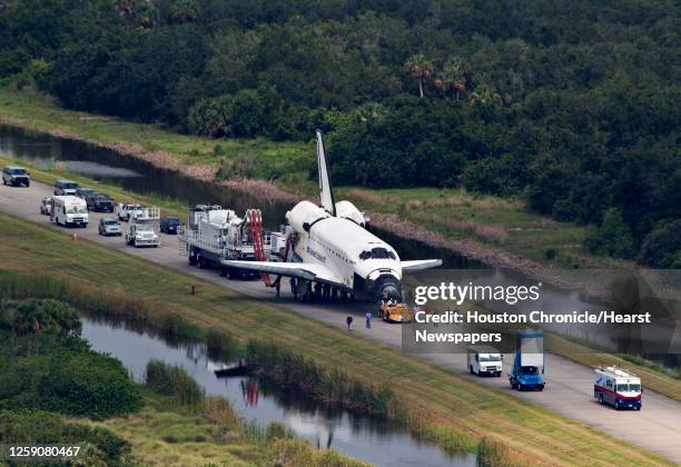 The space shuttle Atlantis is towed from the landing strip to the OPF ( Orbiter Processing Facility after completing the final mission of the space...