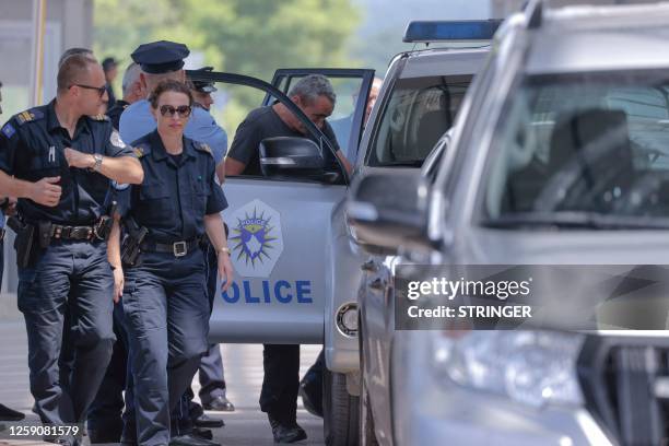 Kosovo's police officers, who were in custody in Serbia, are escorted at the border crossing with Kosovo after their release in Merdare, near the...