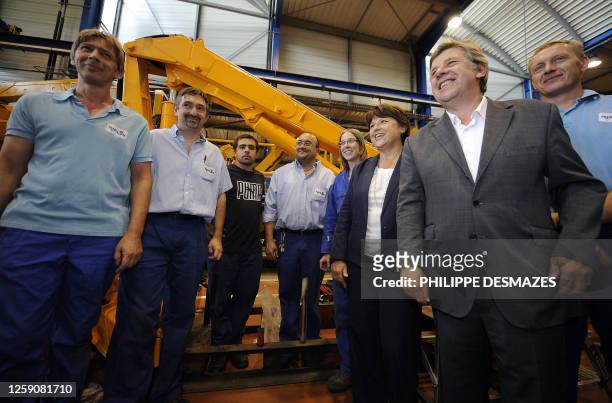 French candidate for the socialist nomination for next year's presidential vote, Martine Aubry poses for the photographers with the workers of the...