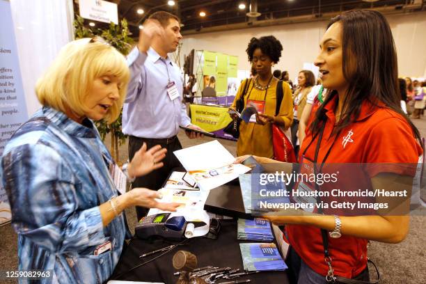 Debbie Clements left foreground and Vince Bonura left rear with MTM Recognition speak with Houston Rockets HR Generalist Sonia Christian right front...