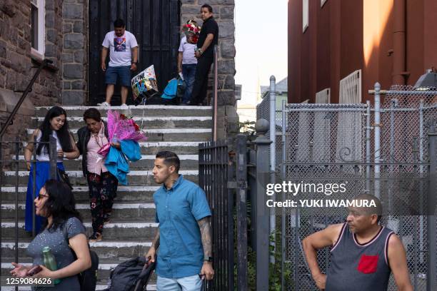 Undocumented migrants and their relatives leave a family reunion event in Queens, New York on June 25, 2023. Some 31 families attended the event...