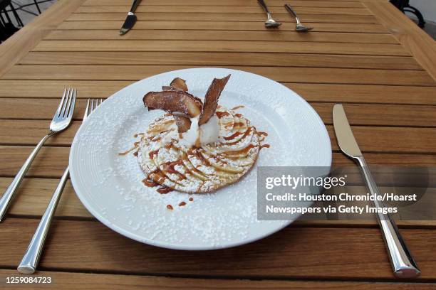 The thin apple tart with vanilla ice cream and caramel sauce at Étoile Cuisine et Bar Thursday, Oct. 25 in Houston.