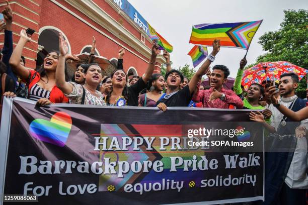 Gender rights activists and supporters of the LGBTQ community hold a banner and pride flags during the parade in Kolkata. The LGBTQ community people...