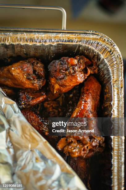 Los Angeles, CA Jerk chicken wings are part of the huge spread at a birthday party BBQ at Kenneth Hahn State Recreation Area on Saturday, June 3,...