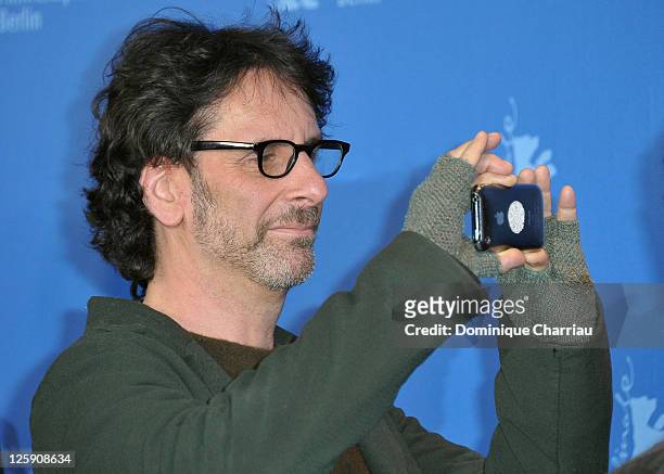 Director Joel Coen takes pictures at the "True Grit" Photocall during the opening day of the 61st Berlin International Film Festival at the Grand...
