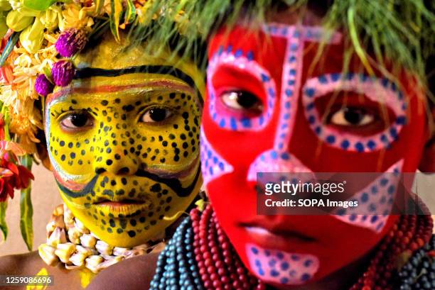 Young children pose with their colorful faces painted as part of their Impersonating Act on the theme of different Tribal Cultures. For generations...