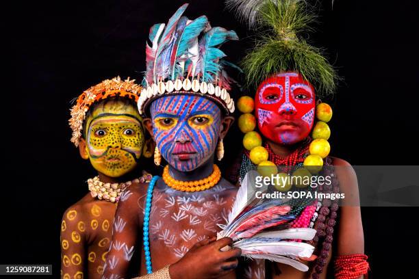 Young children pose with their faces painted as part of their Impersonating Act on the theme of different Tribal Cultures. For generations Bahurupi...