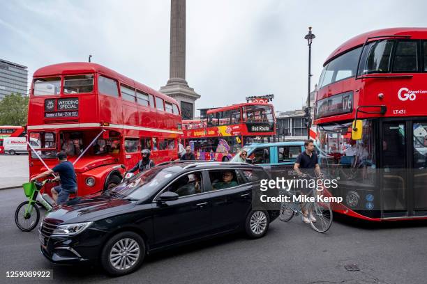Cyclists struggling to navigate their way through gridlocked bus traffic at Trafalgar Square on 23rd June 2023 in London, United Kingdom. Cycling is...