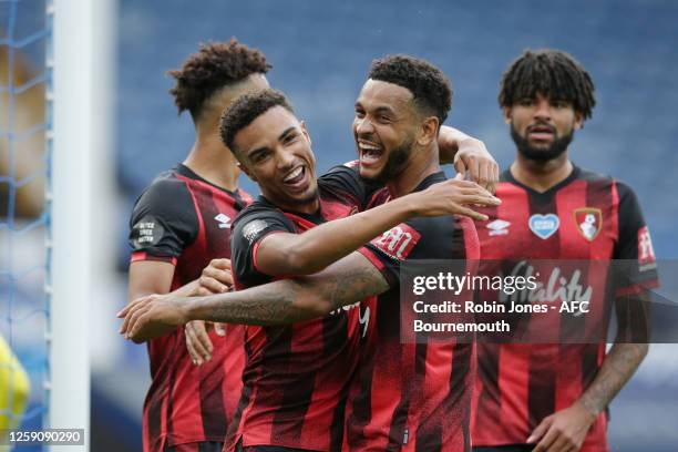 Joshua King congratulates team-mate Junior Stanislas of Bournemouth after he scores a goal to make it 3-1 during the Premier League match between...