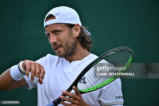 France's Lucas Pouille reacts during his first round match at the Wimbledon qualifying tennis tournament in Roehampton in west London on June 26,...