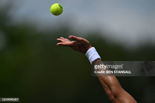 Australia's Thanasi Kokkinakis serves during his first round match during the Wimbledon qualifying tennis tournament in Roehampton in west London on...