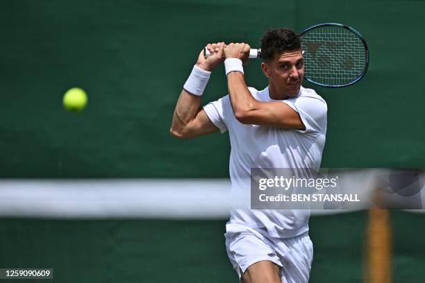 Australia's Thanasi Kokkinakis returns during his first round match during the Wimbledon qualifying tennis tournament in Roehampton in west London on...