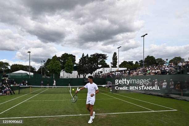 Australia's Thanasi Kokkinakis prepares to serve during his first round match during the Wimbledon qualifying tennis tournament in Roehampton in west...
