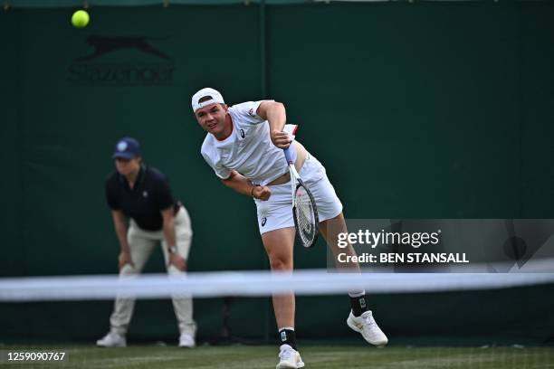 Switzerland's Dominic Stricker serves during his first round match at the Wimbledon qualifying tennis tournament in Roehampton in west London on June...