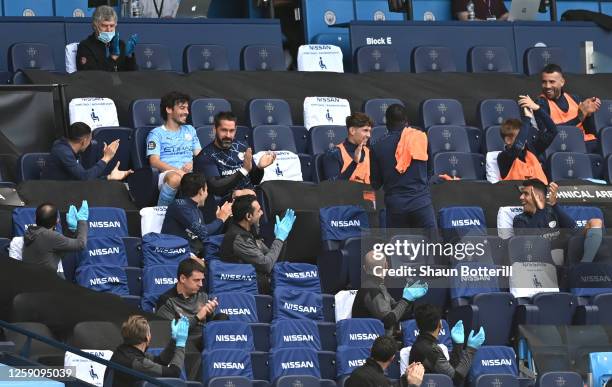 David Silva of Manchester City receives a standing ovation from the Manchester City bench after being substituted in his final appearance for...
