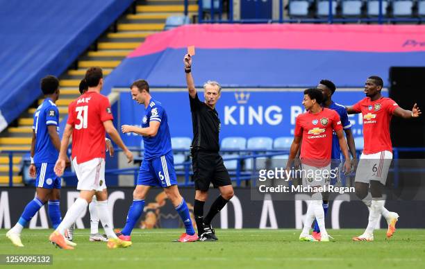 Johnny Evans of Leicester City is shown a red card by referee Martin Atkinson during the Premier League match between Leicester City and Manchester...