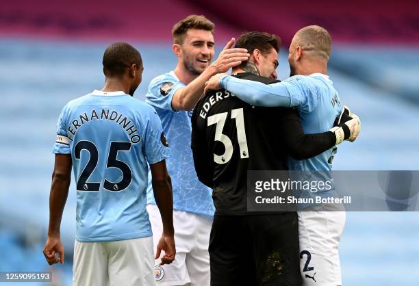 Ederson, Kyle Walker, Fernandinho and Aymeric Laporte all of Manchester City celebrate after the Premier League match between Manchester City and...