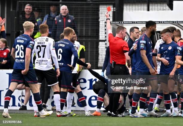 Louth , Ireland - 26 June 2023; Referee Damien MacGraith shows a red card to Rayhaan Tulloch of Dundalk, hidden, during the SSE Airtricity Men's...