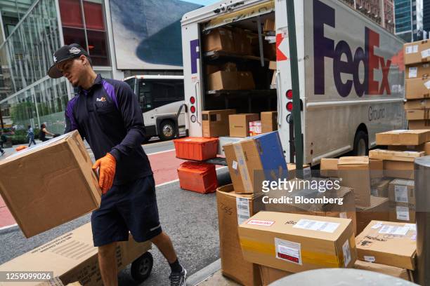 Driver for an independent contractor to FedEx Corp. Unloads packages in New York, US, on Monday, June 26, 2023. FedEx Corp. Said it cut 29,000 US...