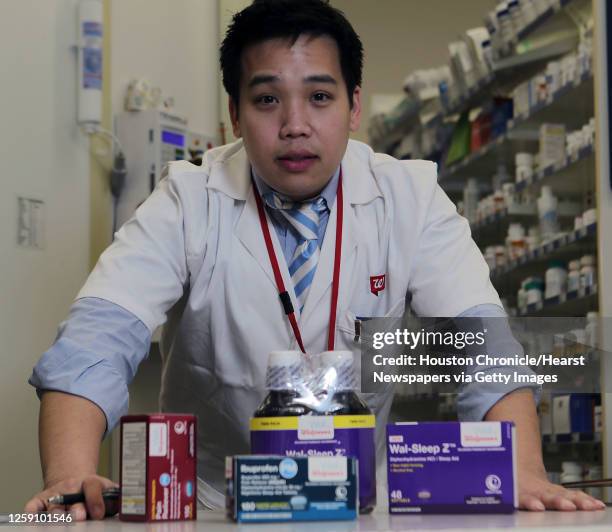 Walgreen's Pharmacist David Tran poses for a portrait with common over the counter cold and flu medicines which can cause complications with some...