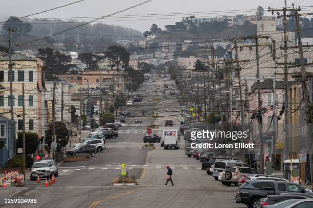Pedestrian crosses a street in the Outer Sunset district by Ocean Beach on June 26, 2023 in San Francisco, California. A recent U.S. Geological...