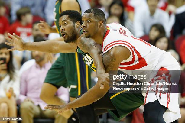 Utah Jazz forward Derrick Favors left, and Houston Rockets forward Terrence Jones right, during the first quarter of NBA game action at the Toyota...