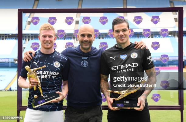 Ederson of Manchester City holds the Golden Glove Award and Kevin De Bruyne of Manchester City holds the Playmaker Award alongside Pep Guardiola,...