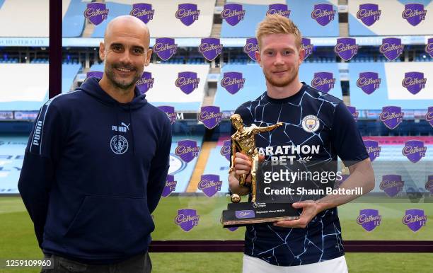 Kevin De Bruyne of Manchester City receives the Playmaker Award from Pep Guardiola, Manager of Manchester City after the Premier League match between...