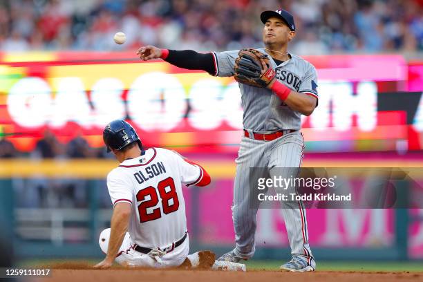 Matt Olson of the Atlanta Braves is out at second as Donovan Solano of the Minnesota Twins turns and throws to first during the fourth inning at...