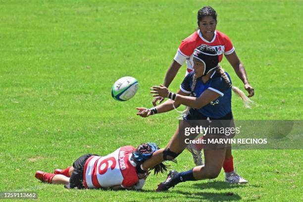 Venezuela's Anibel Diaz fights for the ball with Mexico's Alessandra Bender and Jennifer Salomon during their women's rugby 7 match of the XXIV...