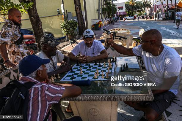 People play chess on 8th Street in Little Havana, Miami, Florida, during a heat wave on June 26, 2023.