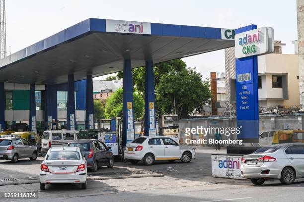 Signage at an Adani Group compressed natural gas pump and filling station in Ahmedabad, India, on Thursday, June 22, 2023. US authorities are looking...