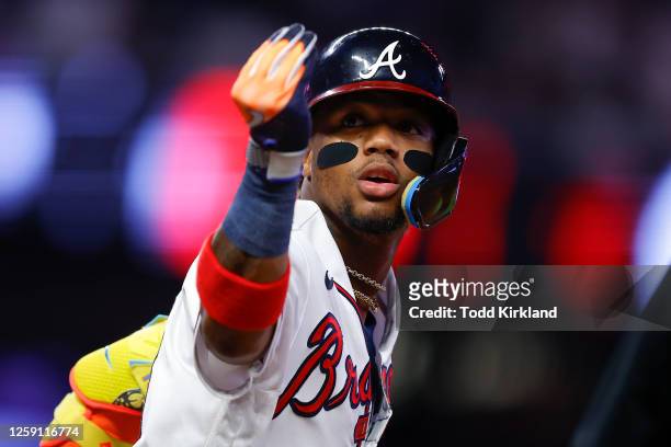 Ronald Acuna Jr. #13 of the Atlanta Braves reacts after hitting a two run home run during the seventh inning against the Minnesota Twins at Truist...