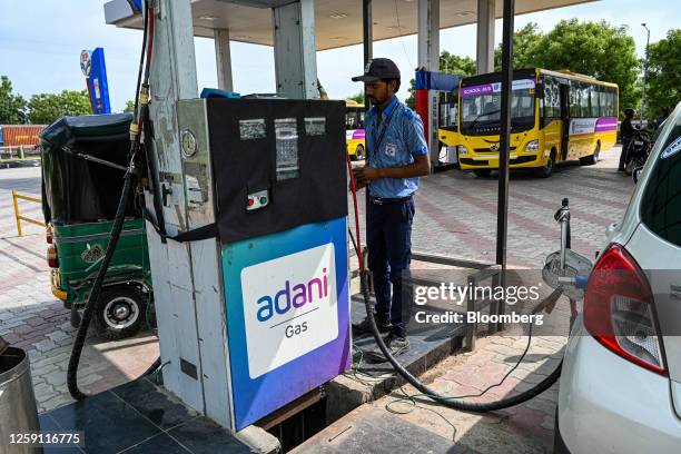 An attendant at an Adani Group pump and filling station in Ahmedabad, India, on Thursday, June 22, 2023. US authorities are looking into what...