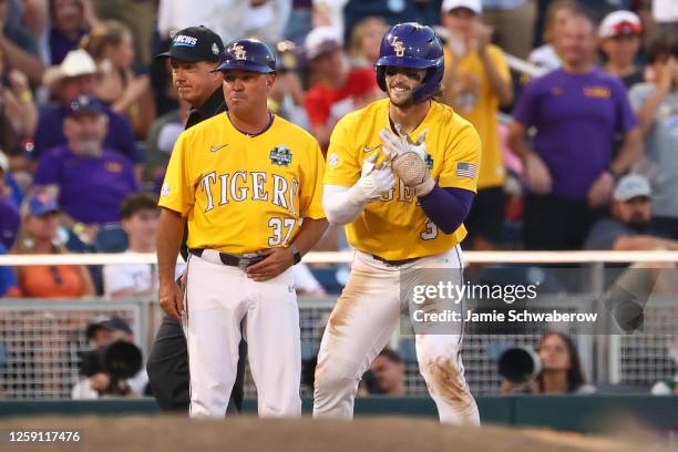 Dylan Crews of the LSU Tigers gestures to his team in the dugout during game three of the Division I Men's Baseball Championship against the Florida...