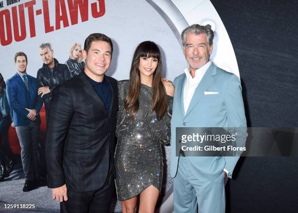 Adam DeVine, Nina Dobrev and Pierce Brosnan at the premiere of "The Out-Laws" held at Regal L.A. Live on June 26, 2023 in Los Angeles, California.