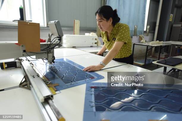 Worker works on an assembly line to produce garments for export orders in Lianyungang, East China's Jiangsu province, June 27, 2023.