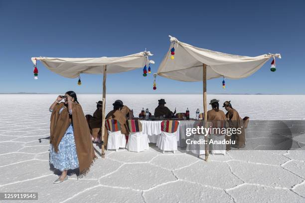 Group of indigenous cholitas from the "Warmi Empollerada" project have lunch at the Salar de Uyuni , southwest Bolivia, on June 24, 2023. The Salar...