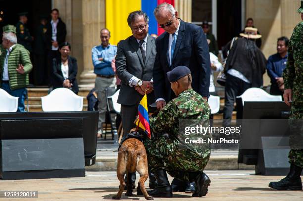 Colombia's president Gustavo Petro and Minister of Defense Ivan Velasquez give honors to Drugia the mother of the dog Wilson who went lost during...