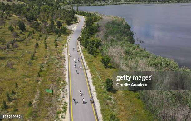 An aerial view of people riding their bicycles and walking by the Lake Eymir ahead of Eid al-Adha holiday taking advantage of the beautiful weather...