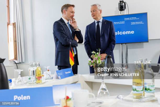 German Finance Minister Christian Lindner and French Minister for the Economy and Finances Bruno Le Maire chat prior to a meeting of the "Weimar...