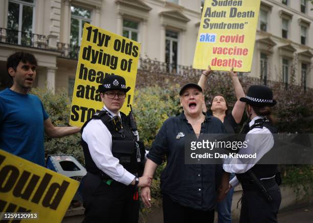 An Anti-vaccination protester is arrested by Police for swearing as she protests outside the Covid-19 Inquiry hearing at Dorland House on June 27,...