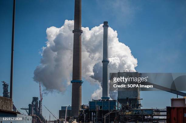 Steam from the chimney of Tata Steel plant seen during the demonstration. Climate activists, Greenpeace and Extinction Rebellion held a demonstration...