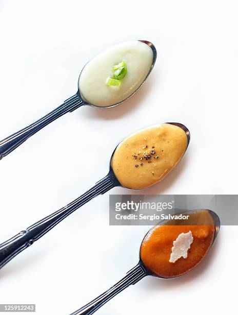 three of spoon bisques - soup on spoon imagens e fotografias de stock